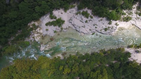 Aerial View of Barton Creek and Tree Tops with People Swimming Below in Austin, Texas