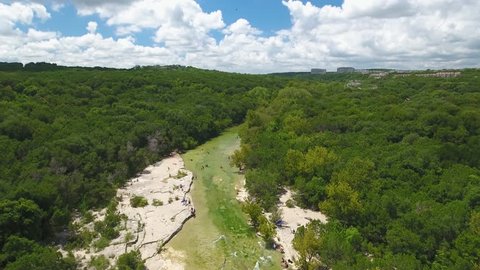 Aerial Flyover at Barton Creek in Austin, Texas with Swimmers and Sun Tanners Below