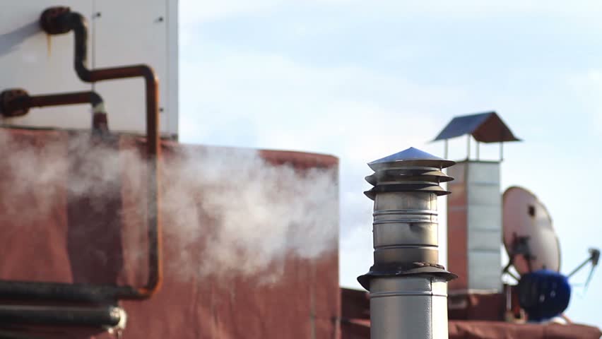 Smoking chimney on the roof of cafe 