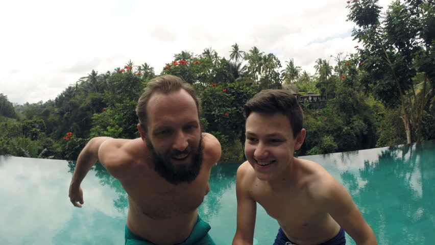 father son jumping into swimming pool Stock Footage Video (100% Royalty ...