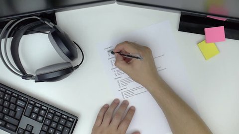 Businessman preparing checklist at office desk