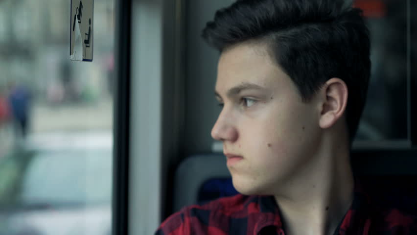 Portrait of pensive youg teenager sitting on bus
