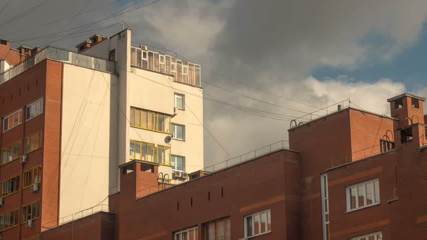 Timelapse of a modern brick building and clouds passing by