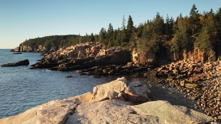 Rocky coastline of Acadia National Park at Monument Beach in early morning light, looking south towards Otter Point.