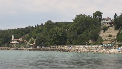 BALCHIK - BULGARIA, AUGUST 17, 2012, Timelapse of tourist people swim near famous Castle by day