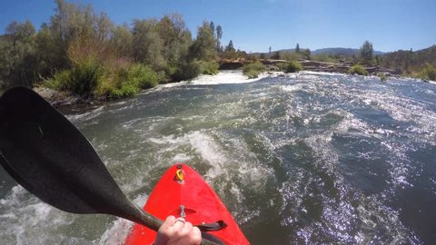 POV of kayaker running class IV powerhouse rapid on the Rogue River in Oregon. 
