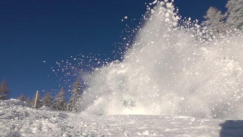 SLOW MOTION CLOSE UP: Big snow avalanche sliding down a mountainside and crush into camera. Triggered snow avalanche flowing down the mountain slope, smashing into camera in snowy winter