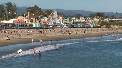 Summer beach scene at Santa Cruz Beach Boardwalk, in California.