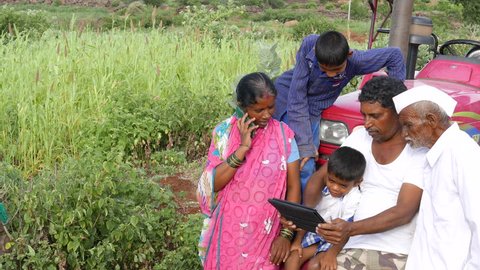 4k Footage of Real farmer family in Veer, Maharashtra using modern technology like Tab and lap top.