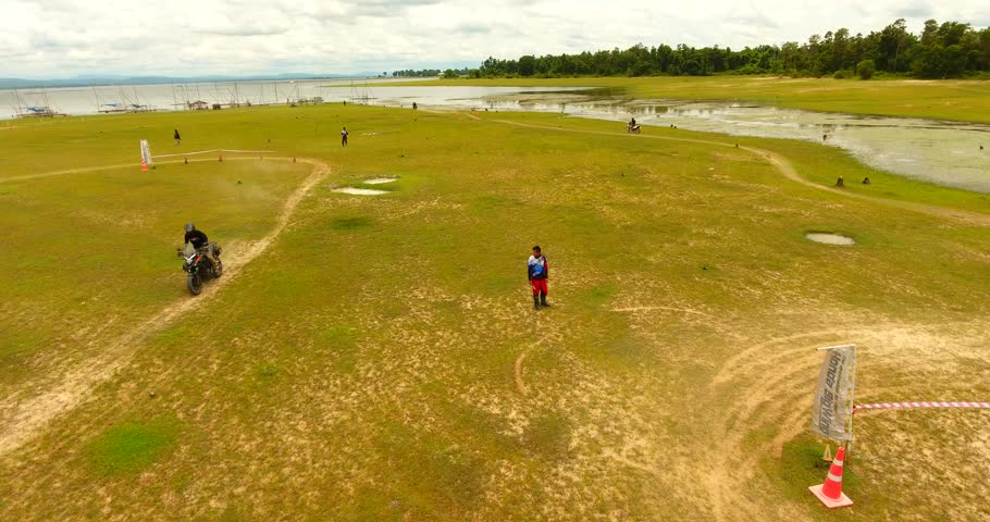 Aerial of motocross dirt track drone following  motocross riders off-road
