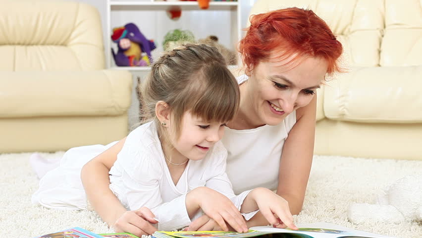 Funny Mother and daughter reading a book