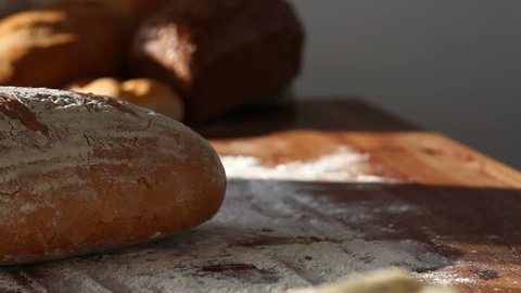 Baker put bread on table, close up, dolly shot