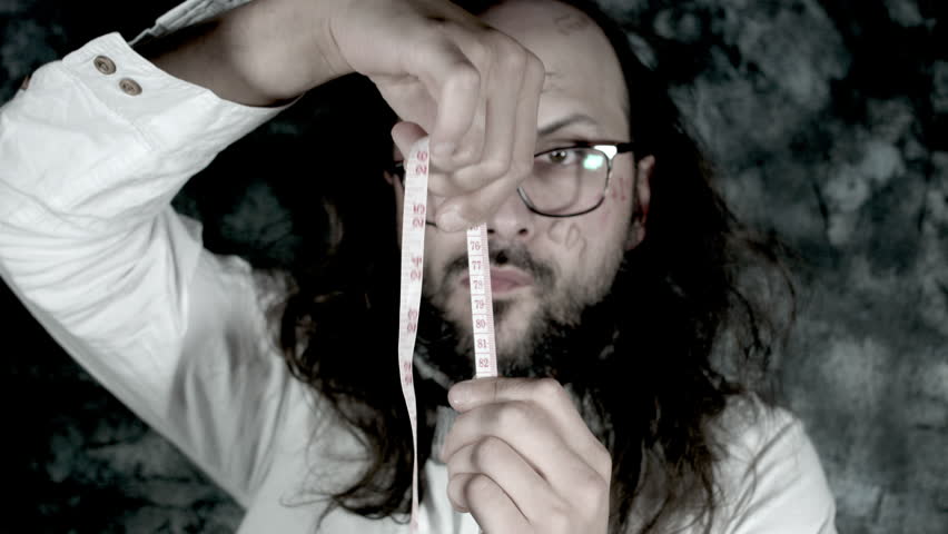 4k Crazy Professor Science Man Playing with a Measuring Tape
