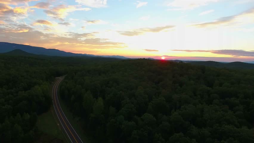 4k epic cinematic aerial of Table Rock State Park in South Carolina at sunrise. Flying over mountains in the up state of South Carolina in the morning. 