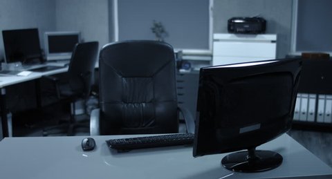4K: A young woman sits down to her computer workstation and starts to read her mails and to answer. Besides, she is surely relaxed in a modern office.