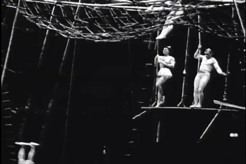 Performers put on a show on the flying trapeze at a circus in the 1930s. (1930s)