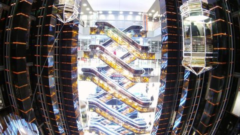 MOSCOW - DEC 21: (Time lapse View) Lifts and escalators move together with visitors in shopping center. Shopping center is Europe, designed by renowned architect Platonov.