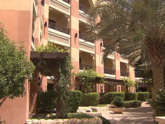 Architecture, Abu Dhabi. View of a landscaped garden outside a luxury hotel complex. Abu Dhabi, UAE - 2013