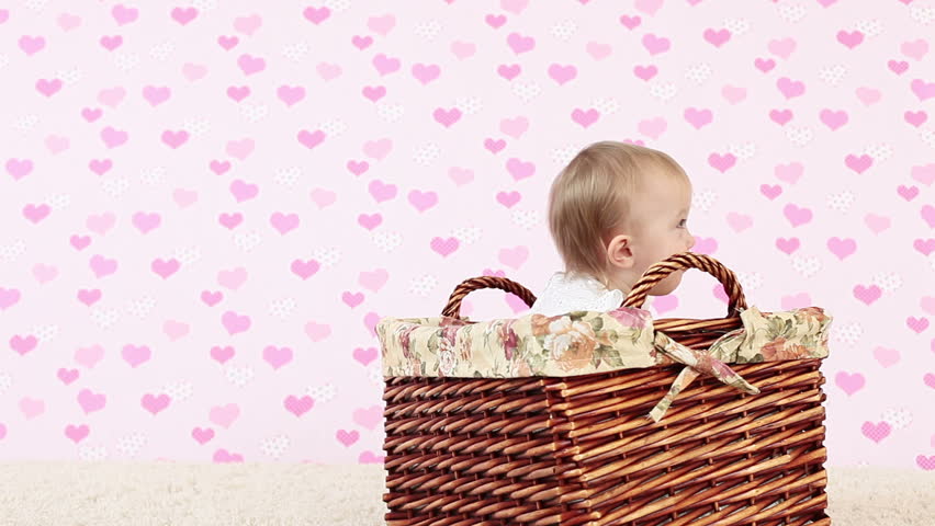 Laughing baby in a wicker basket.