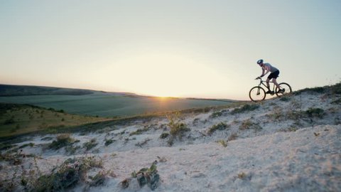 Cyclist riding cross-country through low mountains