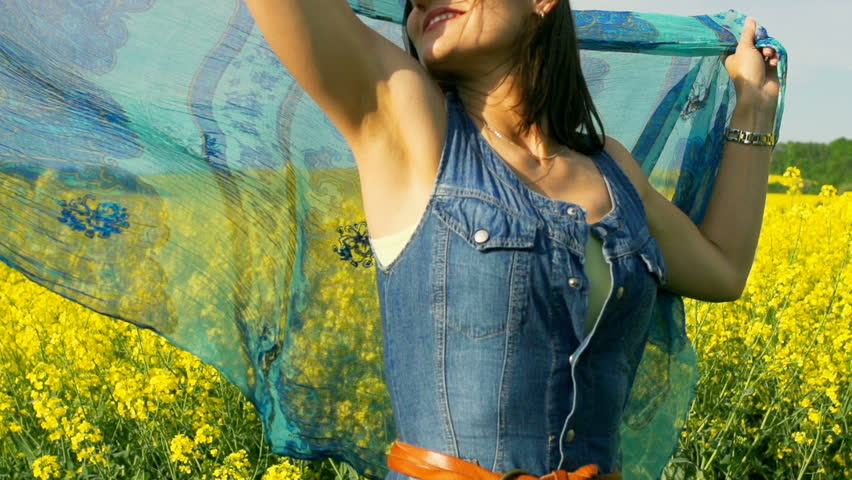 Happy woman holding blue scarf, steadycam shot, slow motion shot at 240fps
