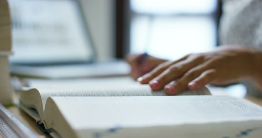 
a happy girl very diligently studying his books and tablets.
concept of connection with the world and education. education and technology combined with the passion for the study .