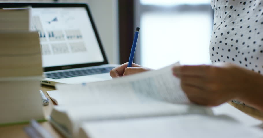 
a happy girl very diligently studying his books and tablets.
concept of connection with the world and education. education and technology combined with the passion for the study .