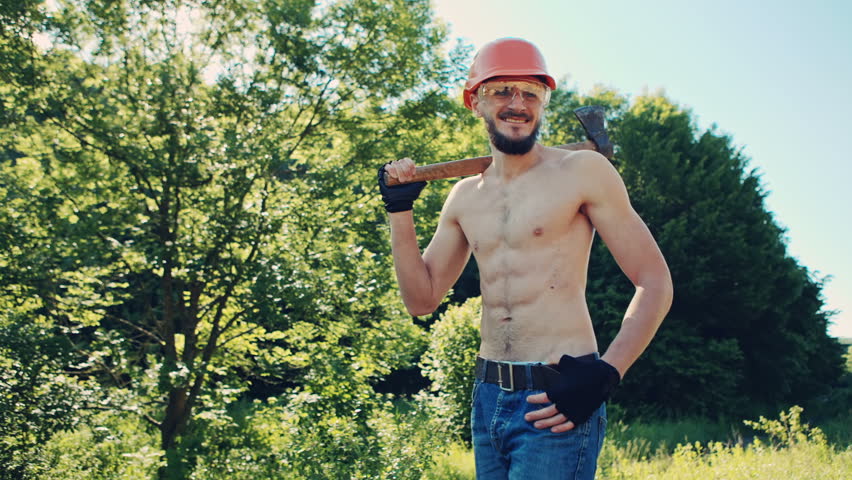 Lumberjack with an ax resting on his shoulder. RAW video record.