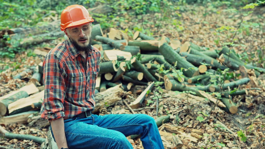 Young lumberjack resting after a hard day. RAW video record.