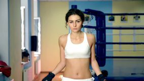 Female Boxer training with Skipping rope in Boxing club. - Powered by Shutterstock - Get 15% off with code: PIKWIZARD15