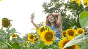 Attractive girl model does selfie near sunflowers. HD
