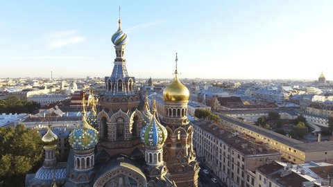 Russia, Saint-Petersburg, 2 September 2016: Aero video filming of the cathedral Church of the Savior on Blood at sunset, gold domes and crosses shine, roofs of St. Petersburg, power, a panorama,