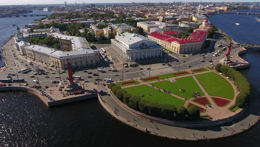 Day traffic is on the Spit of Vasilyevsky island. Buildings of the Old Saint Petersburg Stock Exchange and the Kunstkamera. St. Petersburg, Russia