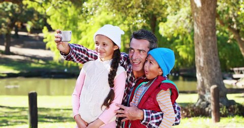 Father with his children taking selfie in park 4k