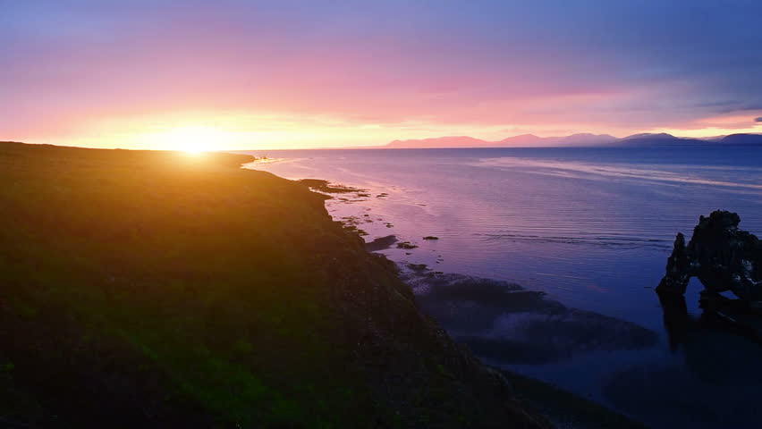 Hvitserkur is a spectacular rock in the sea on the Northern coast of Iceland. On this photo Hvitserkur reflects in the sea water after the midnight sunset.
