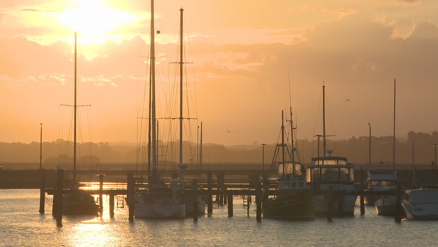 Yachts at their moorings as the sun sets
