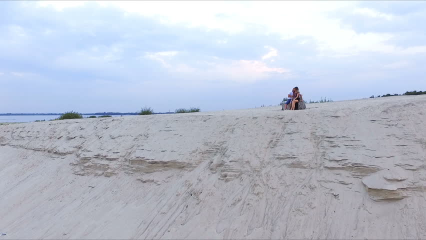 boy and girl on the bank of the river - looking into the distance
