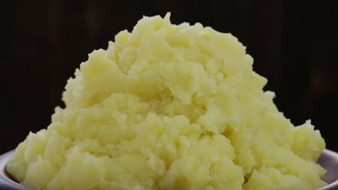 Ukrainian national food is mashed potatoes in plate, close up. Rotates plate with mashed potatoes