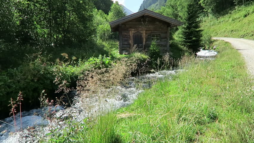 weathered barn on a small stream in European alps. Schwarzachtal valley in zillertal valley tyrol. (Austria)