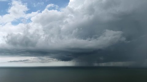Cloudscape and rainstorm over the Pacific Ocean in Panama. Bad weather with clouded sky, rain, thunders. Sea waters, winds, climate change, tropical storm with bolt. Tornado, twister. Time-lapse