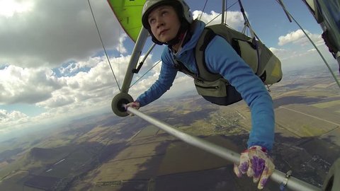 Woman flies on a hang glider with a bird. Eagle tried to attack hang glider circling above and around it, releasing claws and making offensive maneuvers