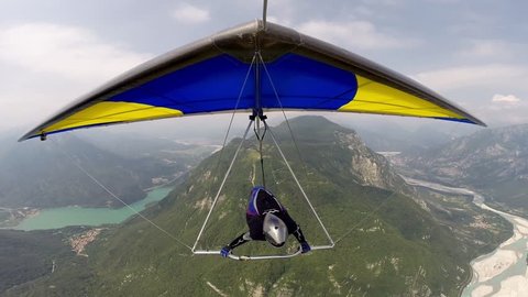Hang glider, a front view in flight. Hangglider pilot flying in the beautiful Austrian mountains
