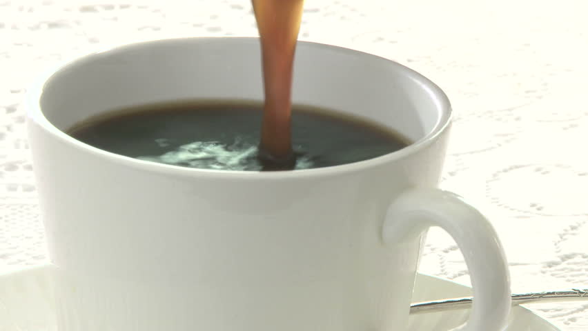 Cream added to cup of coffee