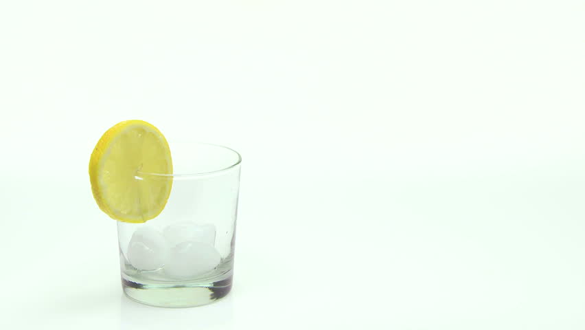 Ice Tea poured into glass with lemon slice