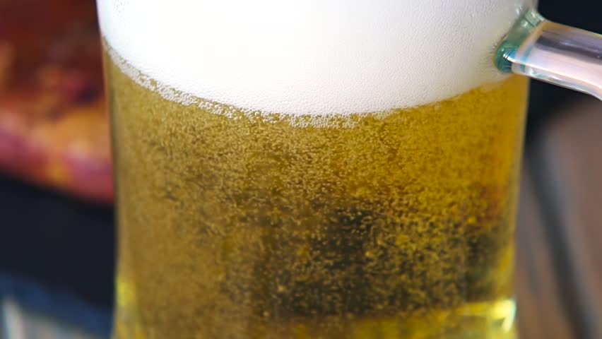 Glass full of beer slow motion bubbles. Beer Bubbles and foam moving fast in glass Royalty-Free Stock Footage #19651486