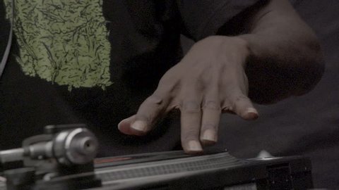 Black DJ hand scratching a vinyl on a turntable. 200 fps slow-motion motion, SLOG3, Close up.