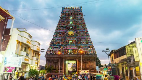 CHENNAI, INDIA - JULY 1, 2016: Famous Arulmigu Kapaleeswarar Temple in Tamil Nadu at night. Time-lapse of illuminated entrance with nightlife around