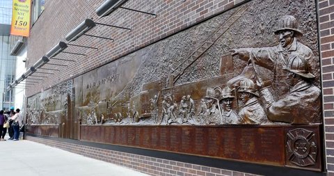 NEW YORK CITY - MAY 12, 2015: The Memorial Wall, located at FDNY Engine 10 Ladder 10, directly across from the World Trade Center site. It's dedicated to the 343 members of the NYFD who died on 9/11.