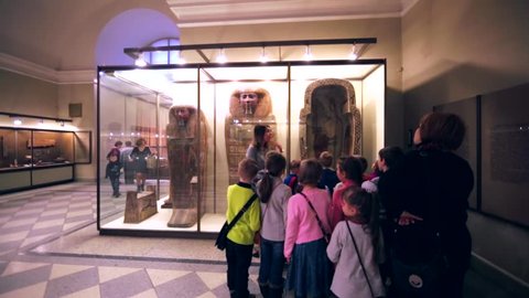 SAINT PETERSBURG, RUSSIA - FEBRUARY 12, 2016: Children and museum guide are near egypt sarcophaguses in Hermitage, one of the largest museums in the world, founded in 1764 by Catherine II.