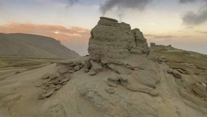 The Sphinx of Bucegi, in the Bucegi Plateau, at sunset with clouds
